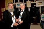 President John receives the Peter James Robinson Trophy from District Governor Graham Jackson.